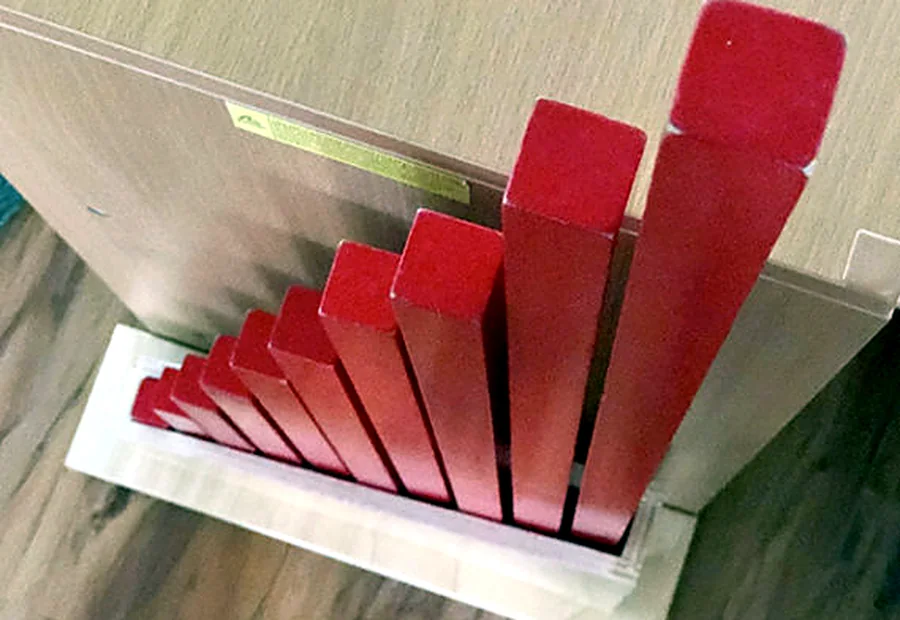 Montessori pink tower sensorial material arranged on a shelf